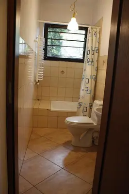 a bathroom with a toilet and a window at Za Rabą in Myślenice
