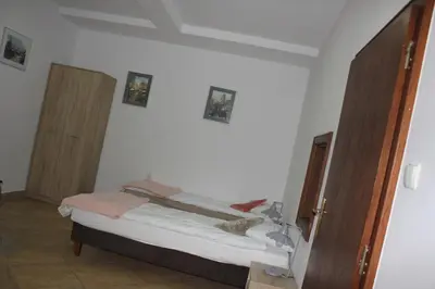 a bedroom with a bed and two open doors at Za Rabą in Myślenice