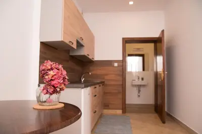 a kitchen with a vase of flowers on a table at Za Rabą in Myślenice