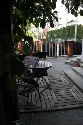 a patio with a table and chairs on a patio at Za Rabą in Myślenice