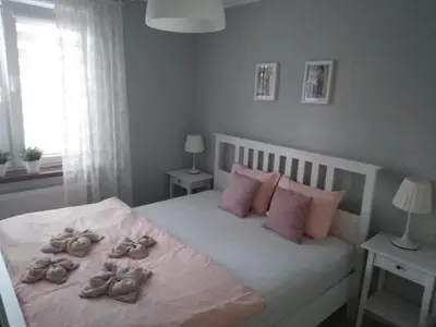 a bedroom with a bed with shoes on it at Apartament Julek klimatyzowany in Oświęcim