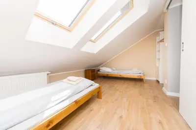 a attic bedroom with two beds and skylights at Blue Apartment Old Town Air Condition p4you pl in Kraków
