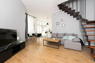 a living room with a couch and a table at Blue Apartment Old Town Air Condition p4you pl in Kraków