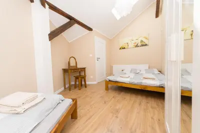 a bedroom with two beds and a table at Blue Apartment Old Town Air Condition p4you pl in Kraków
