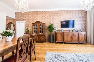 a living room with a wooden table and a television at Apartament w centrum Krakowa Krakowska 10 in Kraków