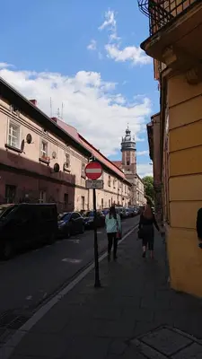 a group of people walking down a city street at Apartament w centrum Krakowa Krakowska 10 in Kraków