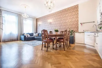 a kitchen and living room with a table and chairs at Apartament w centrum Krakowa Krakowska 10 in Kraków