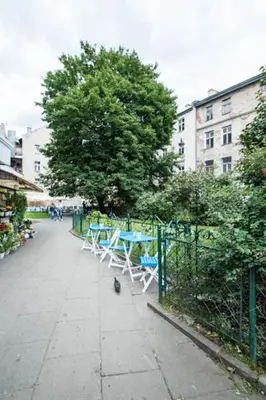 a group of tables and chairs on a sidewalk at Apartament w centrum Krakowa Krakowska 10 in Kraków
