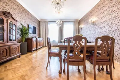 a dining room with a wooden table and chairs at Apartament w centrum Krakowa Krakowska 10 in Kraków