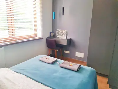 a bedroom with a bed with two towels on it at Dream LUX Apartments in Kraków