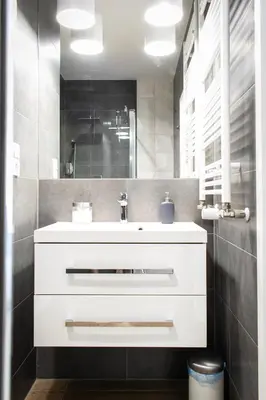 a bathroom with a white sink and a mirror at Dream LUX Apartments in Kraków