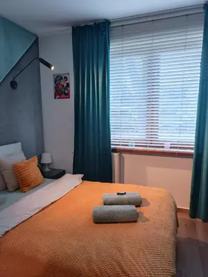 a bedroom with a bed with two towels on it at Dream LUX Apartments in Kraków