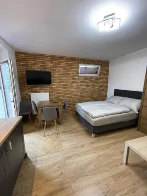 a bedroom with a bed and a table and chairs at Route 7 Rooms in Myślenice