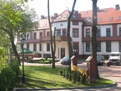 a large building with cars parked in front of it at Pańska Góra in Jaworzno
