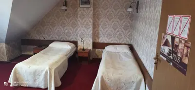 a room with two beds and a staircase at Pańska Góra in Jaworzno