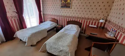a hospital room with two beds and a desk at Pańska Góra in Jaworzno