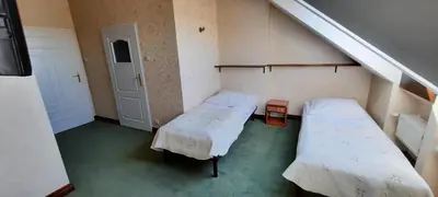 an attic room with two beds and a staircase at Pańska Góra in Jaworzno