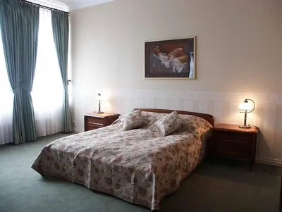 a bedroom with a bed and two night tables and a window at Pańska Góra in Jaworzno
