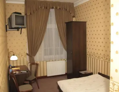 a bedroom with a bed and a tv and a window at Pańska Góra in Jaworzno