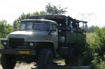 a green army truck parked in a field at Pańska Góra in Jaworzno