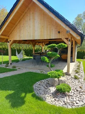 a pavilion with a table and chairs in a yard at Dwór Bysina in Myślenice