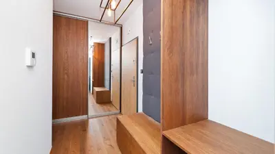 a hallway with wood paneled walls and a stair case at Rakowicka Podkowa City Center, Sun & Snow in Kraków