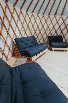 a yurt with two blue pillows in a room at Jeżowa Woda Ośrodek Wypoczynkowy Palmiarnia i SPA in Przyszowa