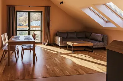 a living room with a couch and a table at Jeżowa Woda Ośrodek Wypoczynkowy Palmiarnia i SPA in Przyszowa