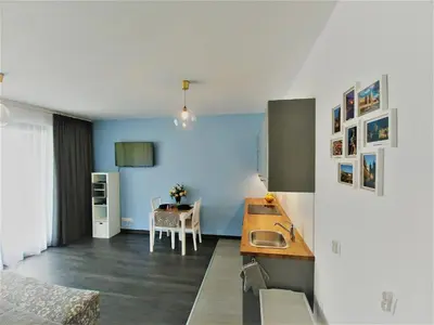 a kitchen with a sink and a table at Apartamenty Retmana in Kraków