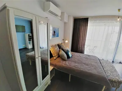 a hotel room with a bed and a window at Apartamenty Retmana in Kraków
