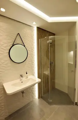 a bathroom with a sink and a shower at Wawrzyńca Brick Apartment Kazimierz in Kraków