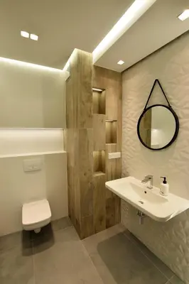 a bathroom with a sink and a toilet and a mirror at Wawrzyńca Brick Apartment Kazimierz in Kraków