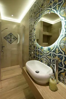 a bathroom with a sink and a shower and a mirror at Piłsudskiego In City Apartments in Kraków