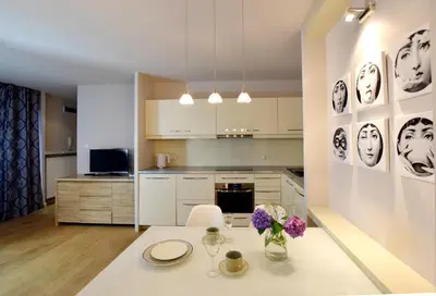 a kitchen with a table with flowers on it at Piłsudskiego In City Apartments in Kraków