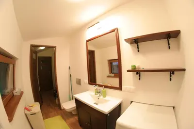 a bathroom with a sink and a toilet and a mirror at Ranczo Dziki Sad in Raciechowice