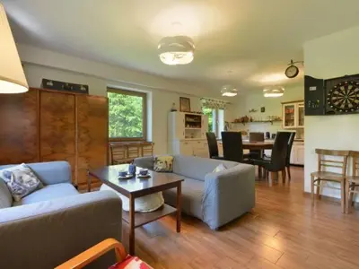 a living room with a couch and a table at Ranczo Dziki Sad in Raciechowice