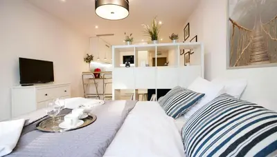 a bedroom with a bed with a tray on it at Rakowicka Apartament in Kraków