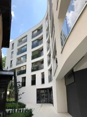an external view of a white building at City of The Kings Piano Apartment in Kraków