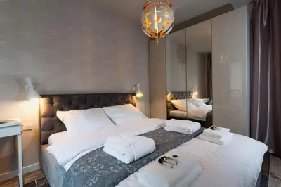 a bedroom with two beds with towels on them at City of The Kings Piano Apartment in Kraków