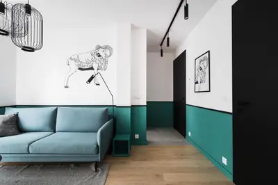a living room with a blue couch and a painting on the wall at Colors Apartments Zator - tylko 10 minut piechotą od Energylandii in Zator