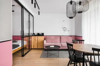 a living room with a pink couch and a table at Colors Apartments Zator - tylko 10 minut piechotą od Energylandii in Zator