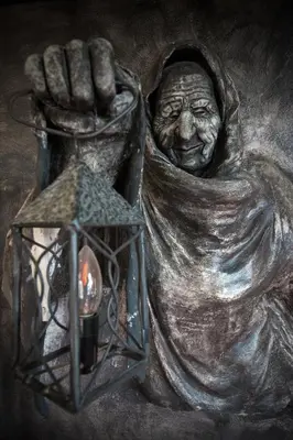 a statue of a woman holding a lantern at Hotel Kasztel in Rzezawa