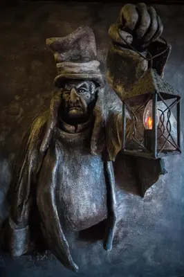 a painting of a statue holding a lantern at Hotel Kasztel in Rzezawa