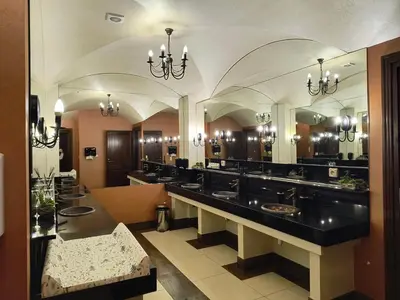 a large bathroom with sinks and a large mirror at Hotel Kasztel in Rzezawa