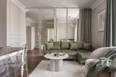 a living room with a couch and a table at District17 by StayLab in Kraków