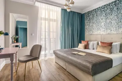 a bedroom with a bed and a desk and a chair at District17 by StayLab in Kraków