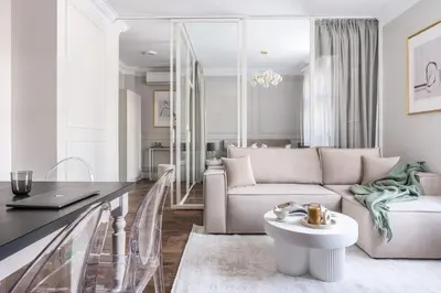 a living room with a couch and a table at District17 by StayLab in Kraków