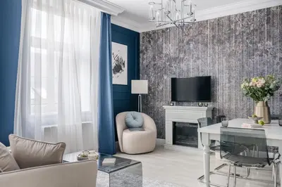 a living room with a couch and a table and a tv at District17 by StayLab in Kraków