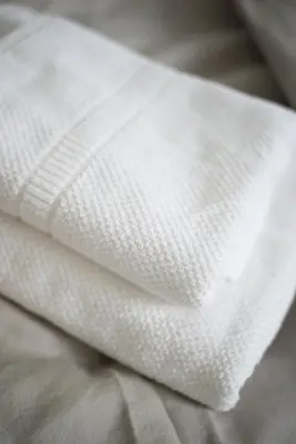 a close up of a white napkin on a bed at u Jagody in Mszana Dolna
