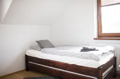 a bed sitting in a room with a window at u Jagody in Mszana Dolna